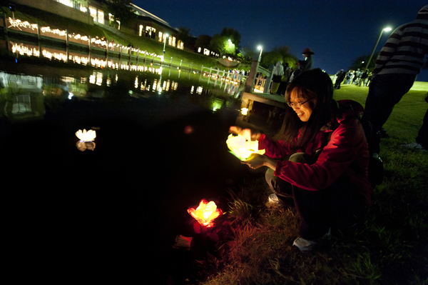 A student celebrates the International Festival next to Chadwick Lake