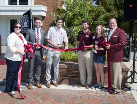 Union staff cut a ribbon at a dedication ceremony for a new plaza located at the union